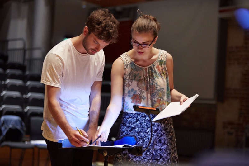 A composer and a mentor looking over a score