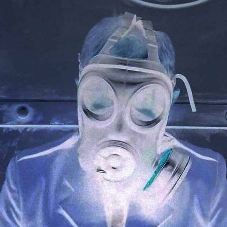 Negative blue image of a man wearing a WW2 style gas mask