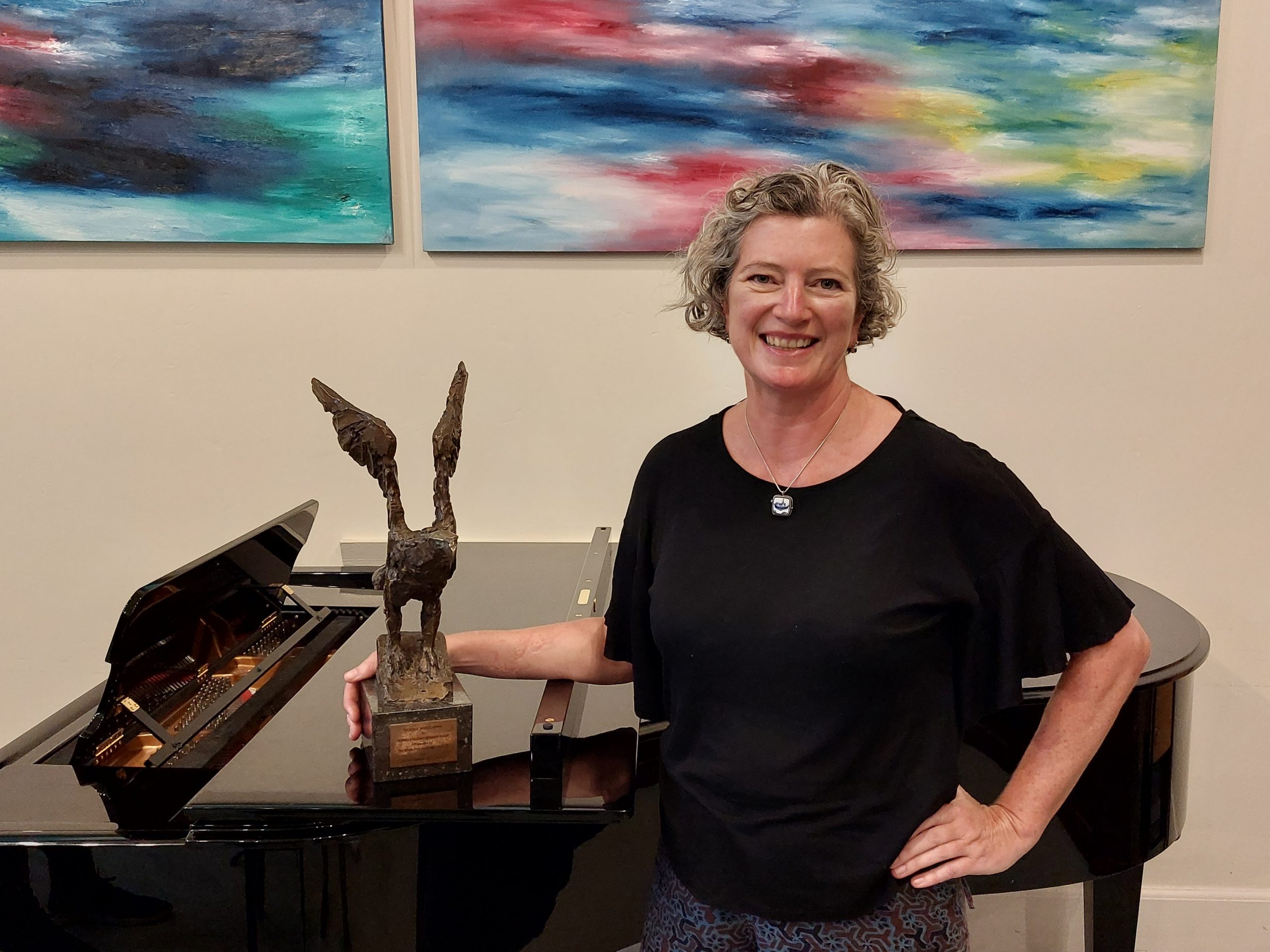 Susanna sat at a grand piano with her Lesley Boosie Award (a bronze eagle on a plinth)