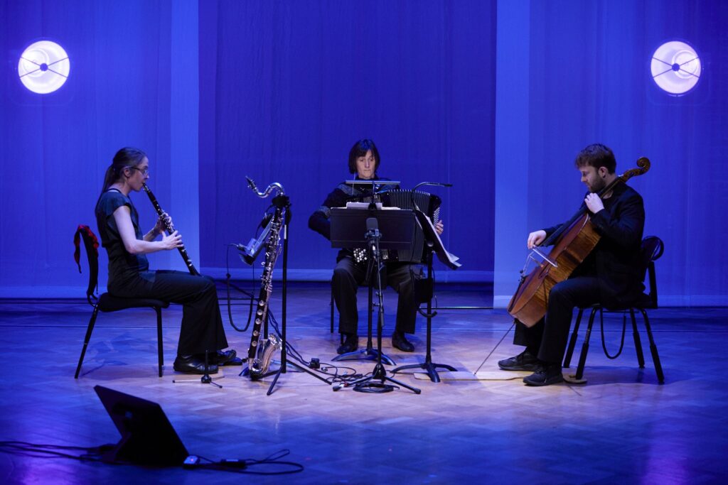 Three musicians in a purple room
