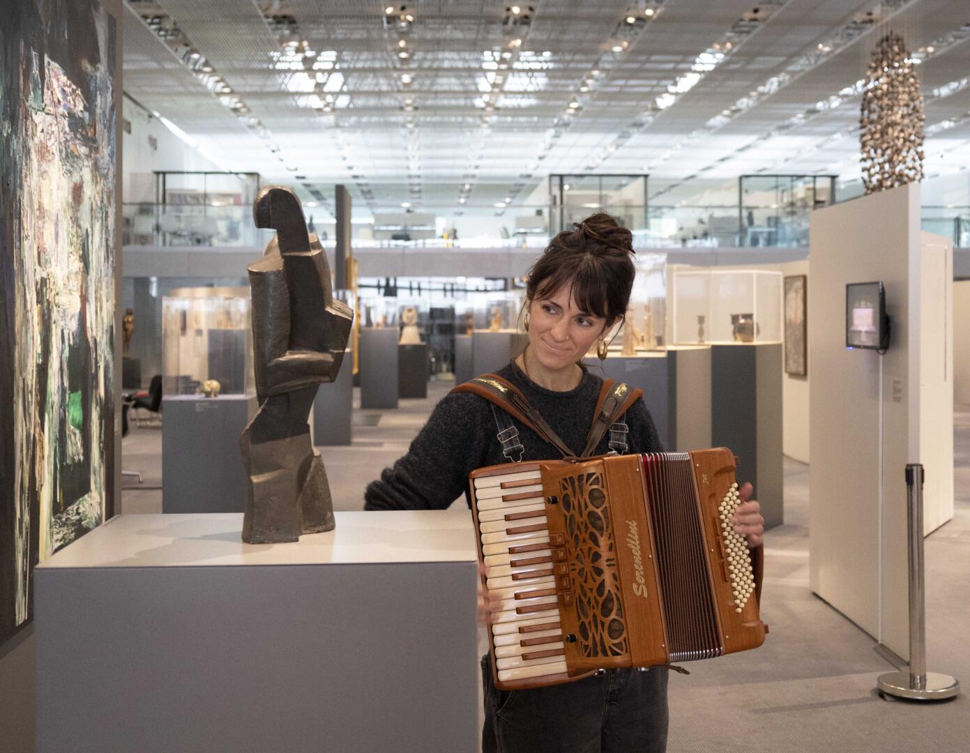 Tamsin Elliot playing the accordion to Ossip Zadkine’s The Accordion Player, 1918, at the Sainsbury Centre. Photo: Kate Wolstenholme